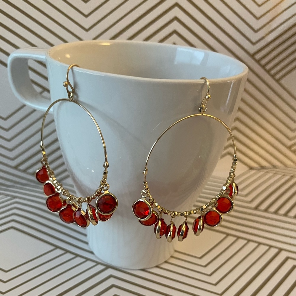 Nicole Miller gold hoops w/ red stones, NWOT, in original packaging. So pretty!